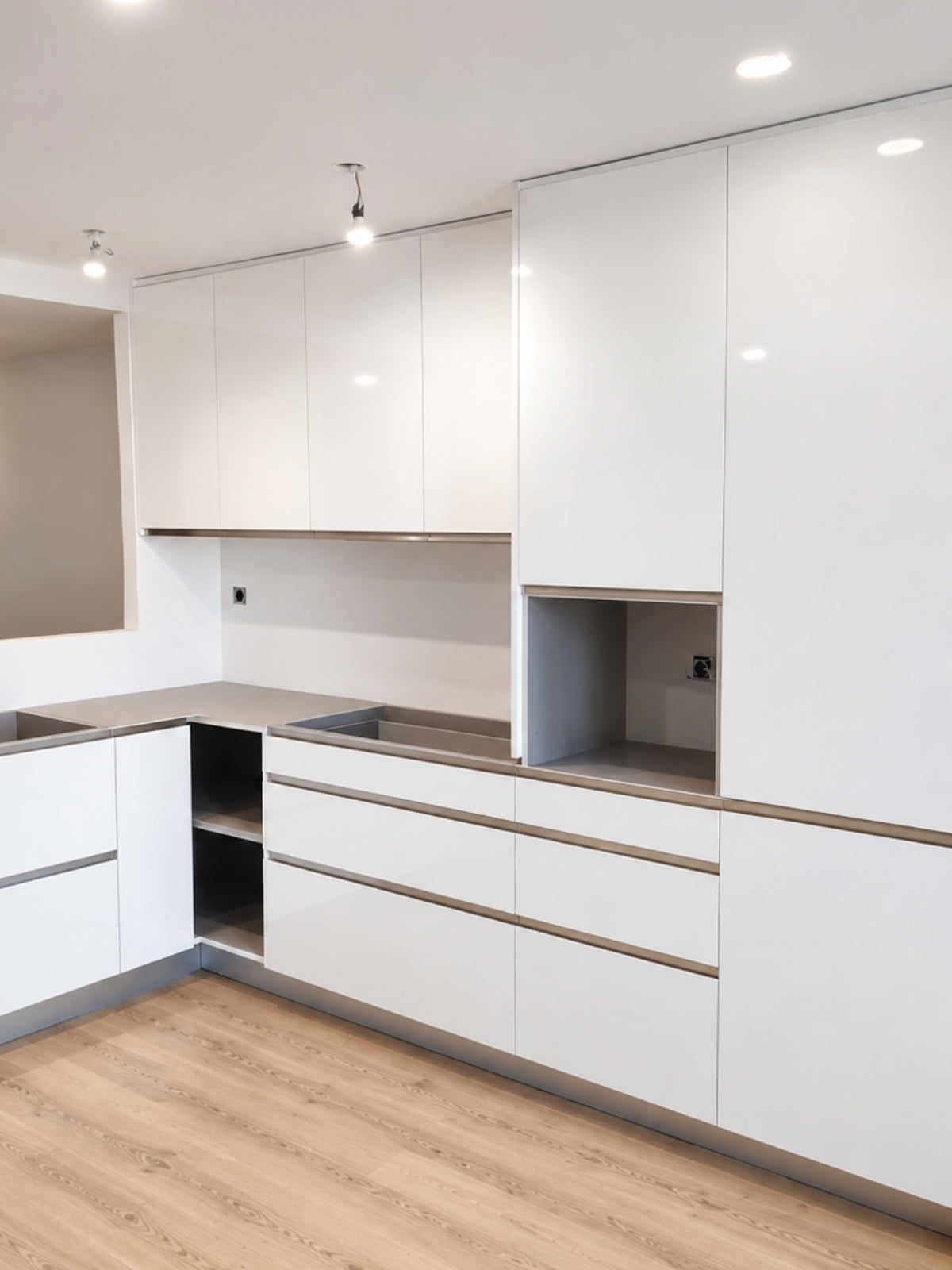 Cocina blanca en L a medida con columnas y gran capacidad de almacenaje en Vilassar de Mar
